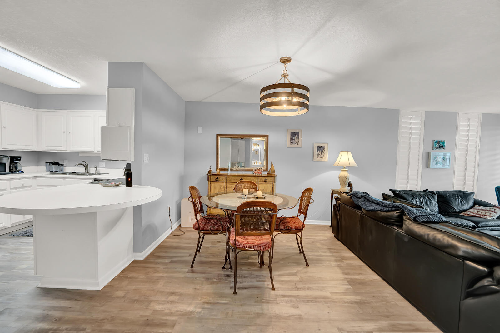 30 Moreno Point Road, Unit 102A Destin, FL 32541 - Photo 19 of 52 a view of a dining room with furniture wooden floor and chandelier