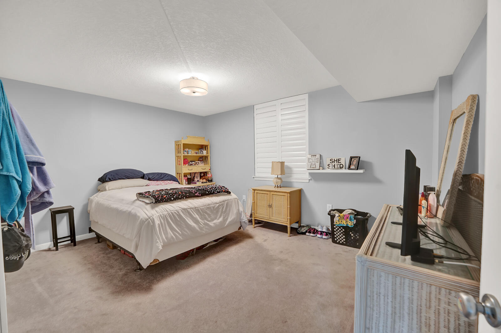 30 Moreno Point Road, Unit 102A Destin, FL 32541 - Photo 6 of 52 a bedroom with a bed a flat screen tv and dresser