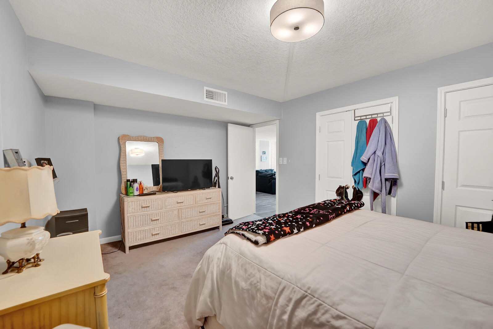 30 Moreno Point Road, Unit 102A Destin, FL 32541 - Photo 8 of 52 a bedroom with a bed and a flat screen tv