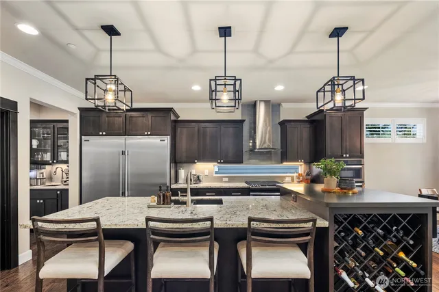 a kitchen area with granite countertop a table and chairs