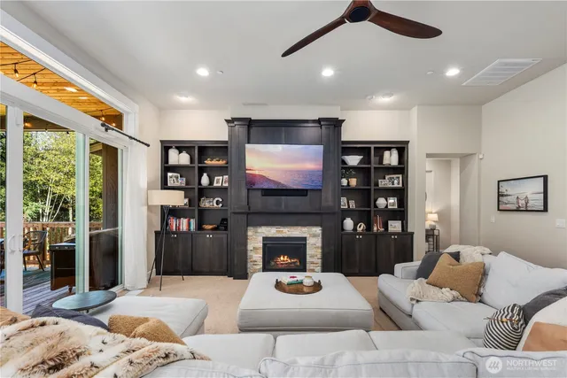 a living room with furniture a fireplace and a flat screen tv