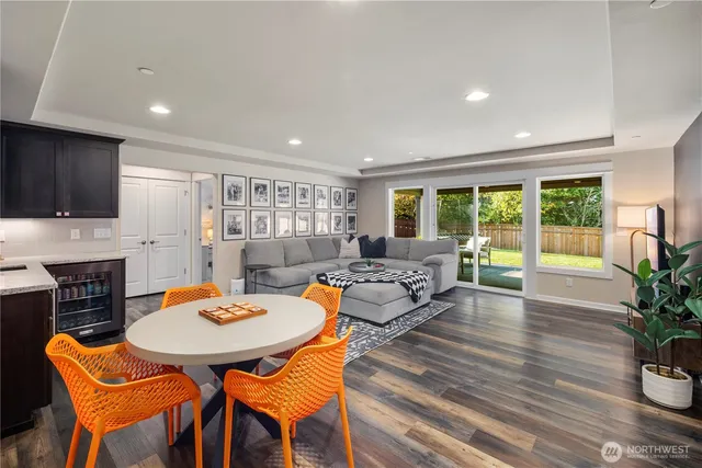 a dining room with furniture and wooden floor