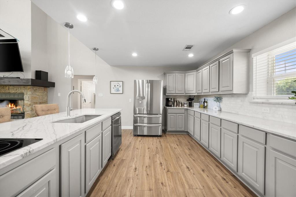 113 Cinch Buckle Ranch Road Trinidad, TX 75163 - Photo 14 of 36 a kitchen with stainless steel appliances a sink cabinets and wooden floor