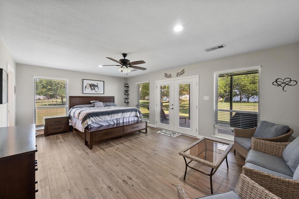 113 Cinch Buckle Ranch Road Trinidad, TX 75163 - Photo 18 of 36 a bedroom with a bed and wooden floor