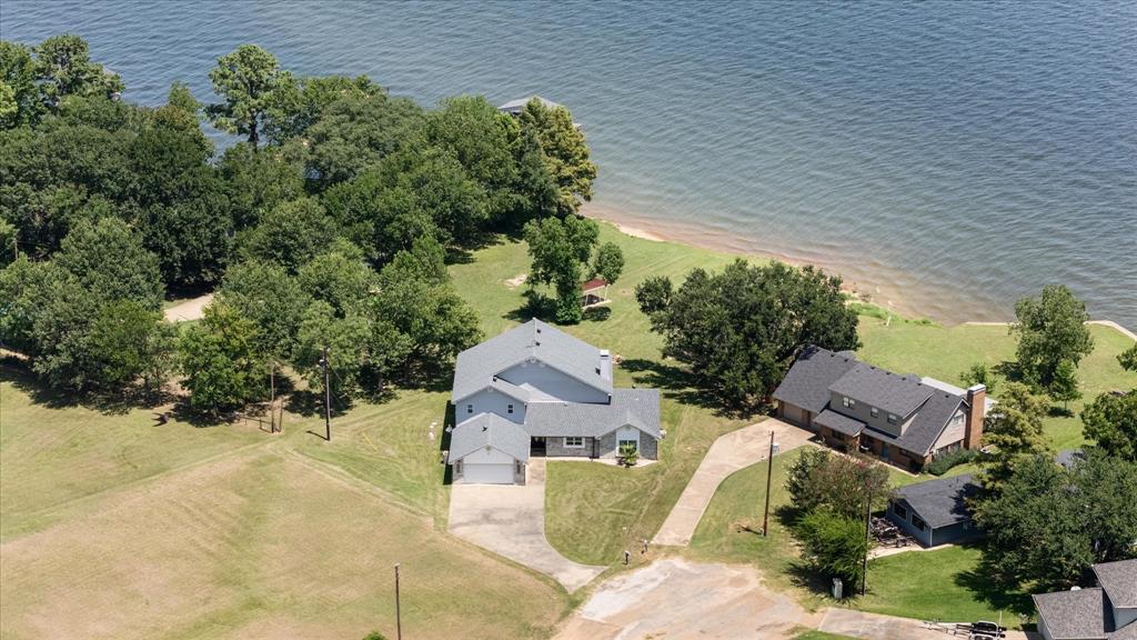 113 Cinch Buckle Ranch Road Trinidad, TX 75163 - Photo 2 of 36 an aerial view of a house with a yard and trees