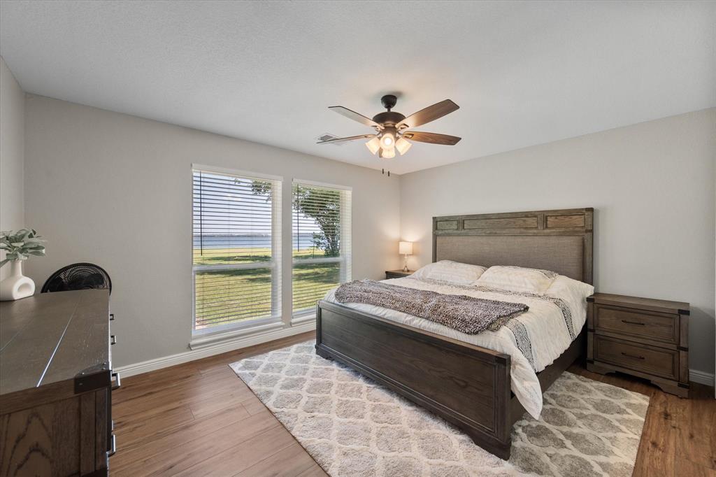 113 Cinch Buckle Ranch Road Trinidad, TX 75163 - Photo 24 of 36 a bedroom with a bed and a chair