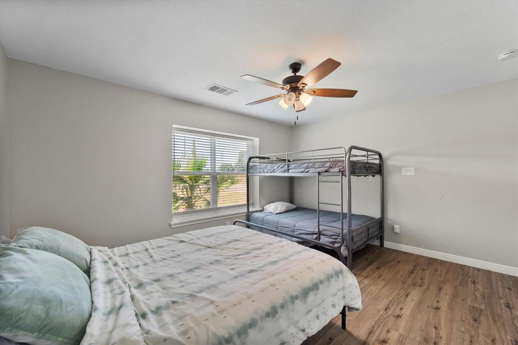 113 Cinch Buckle Ranch Road Trinidad, TX 75163 - Photo 26 of 36 a bedroom with a bed and a chandelier