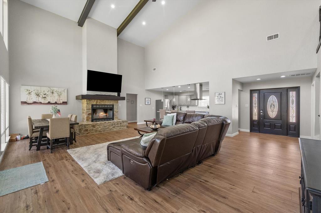 113 Cinch Buckle Ranch Road Trinidad, TX 75163 - Photo 6 of 36 a living room with furniture a fireplace and a flat screen tv