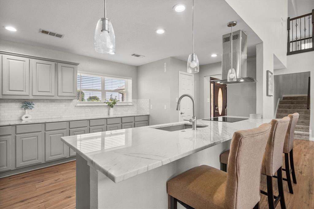 113 Cinch Buckle Ranch Road Trinidad, TX 75163 - Photo 9 of 36 a kitchen with stainless steel appliances granite countertop a table chairs sink and cabinets