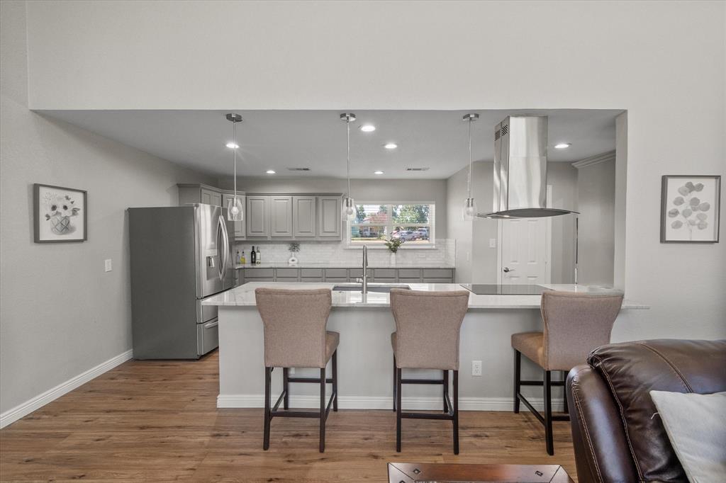 113 Cinch Buckle Ranch Road Trinidad, TX 75163 - Photo 10 of 36 a kitchen with stainless steel appliances a table chairs refrigerator and sink