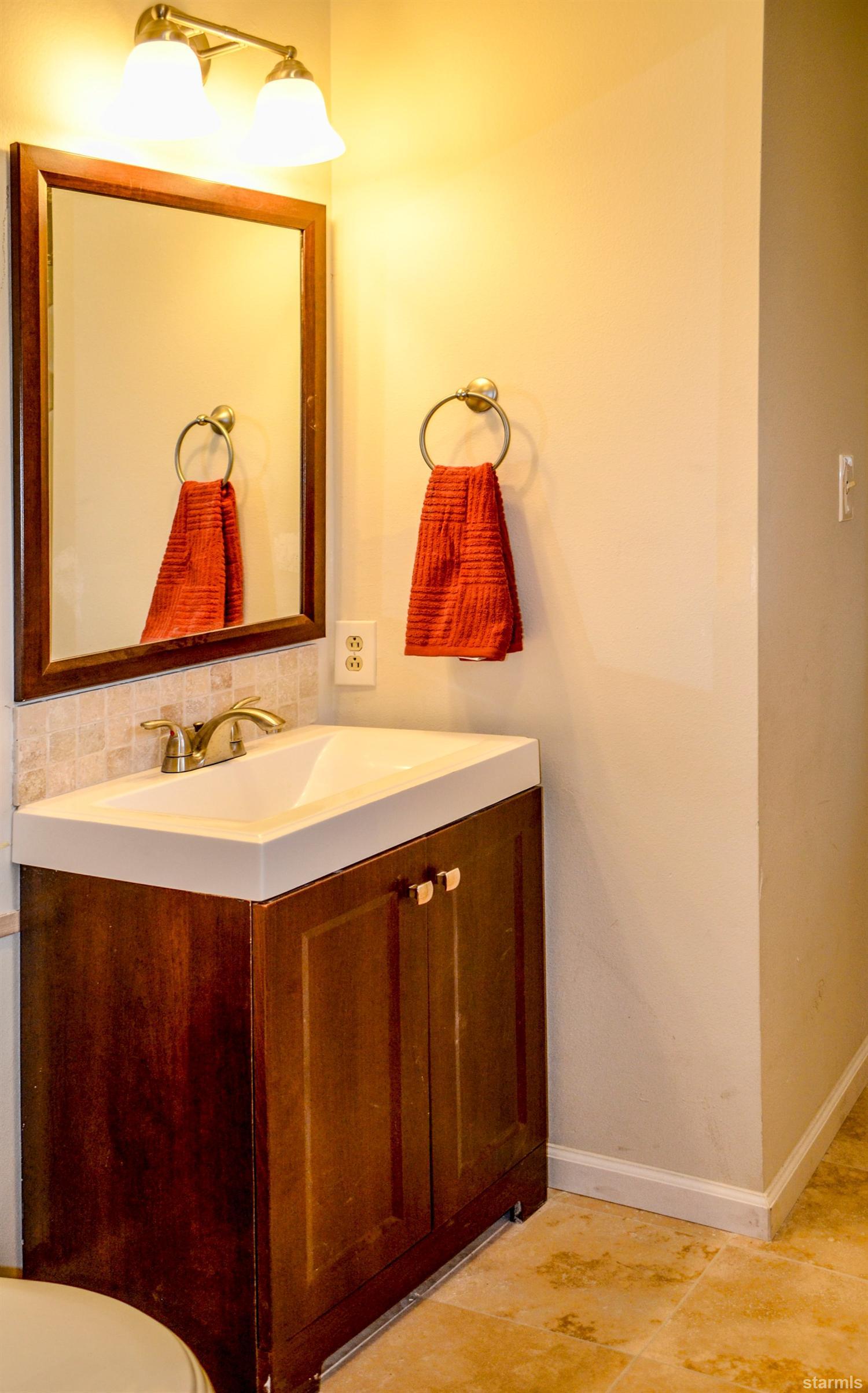 1095 Kings Row Reno, NV 89503 - Photo 21 of 23 a bathroom with a sink and a mirror