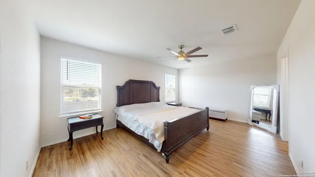 a bedroom with bed and a ceiling fan