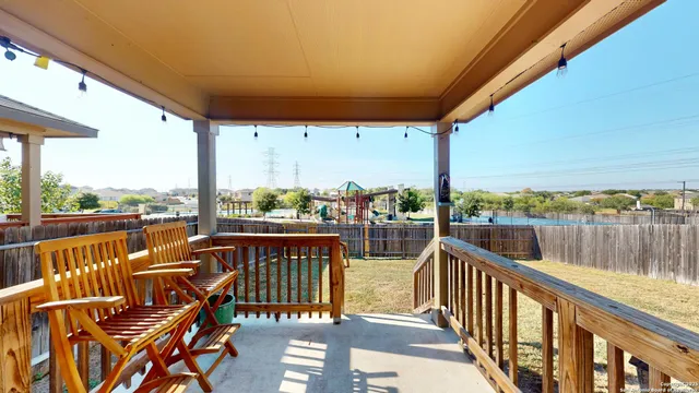 a view of a balcony with wooden floor and outdoor space