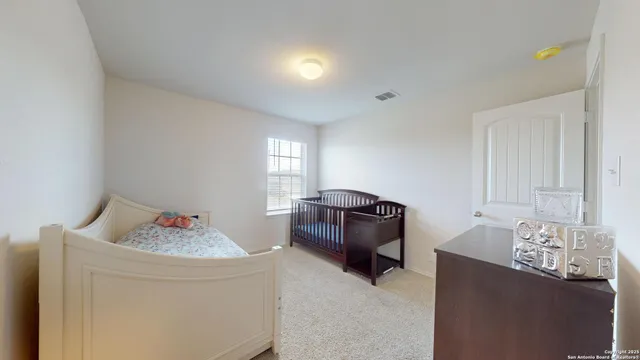 a bedroom with bed and window