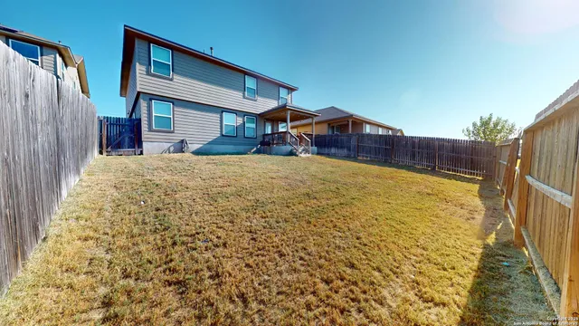 a view of a swimming pool with lawn chairs