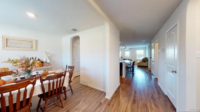 a view of a dining room with furniture and wooden floor