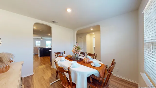 a view of a dining room with furniture and wooden floor