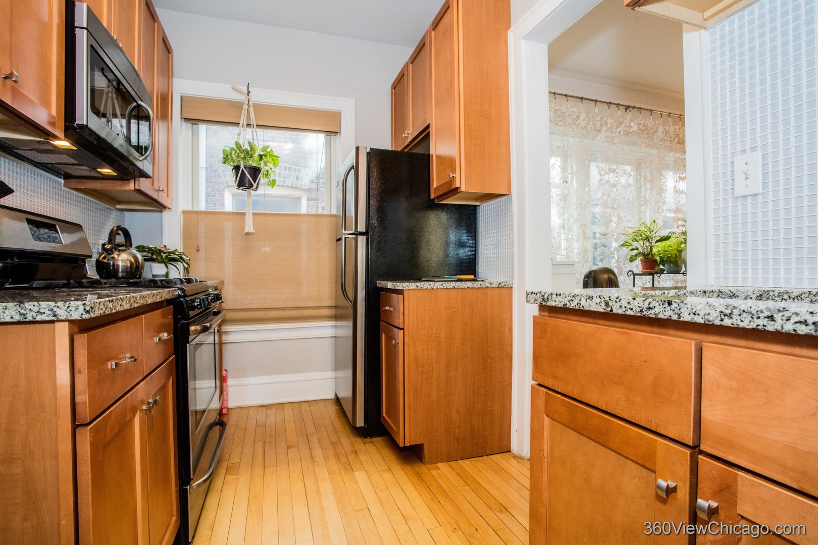 546 West Brompton Avenue, Unit 2S Chicago, IL 60657 - Photo 9 of 17 a kitchen with stainless steel appliances granite countertop a refrigerator a sink and a stove