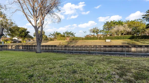 a view of a lake with houses in the back