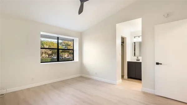 an empty room with windows and closet