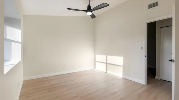 an empty room with a empty space and windows