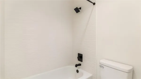 a bathroom with a bathtub and a toilet