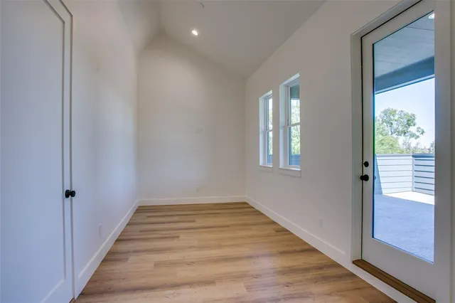 a view of an entryway with wooden floor and door