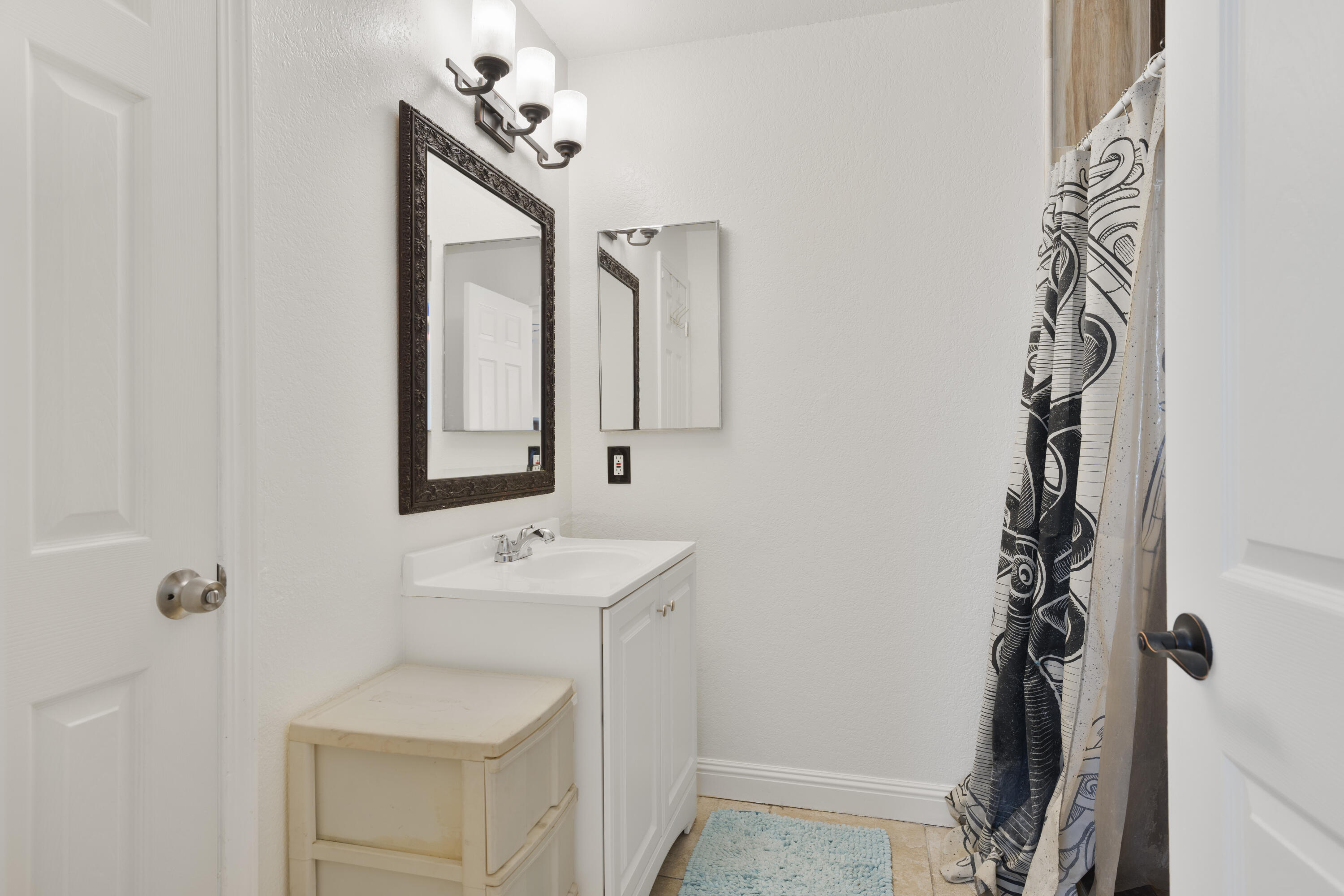 908 Northpoint Place Lompoc, CA 93436 - Photo 11 of 21 a bathroom with a sink a mirror and a shower