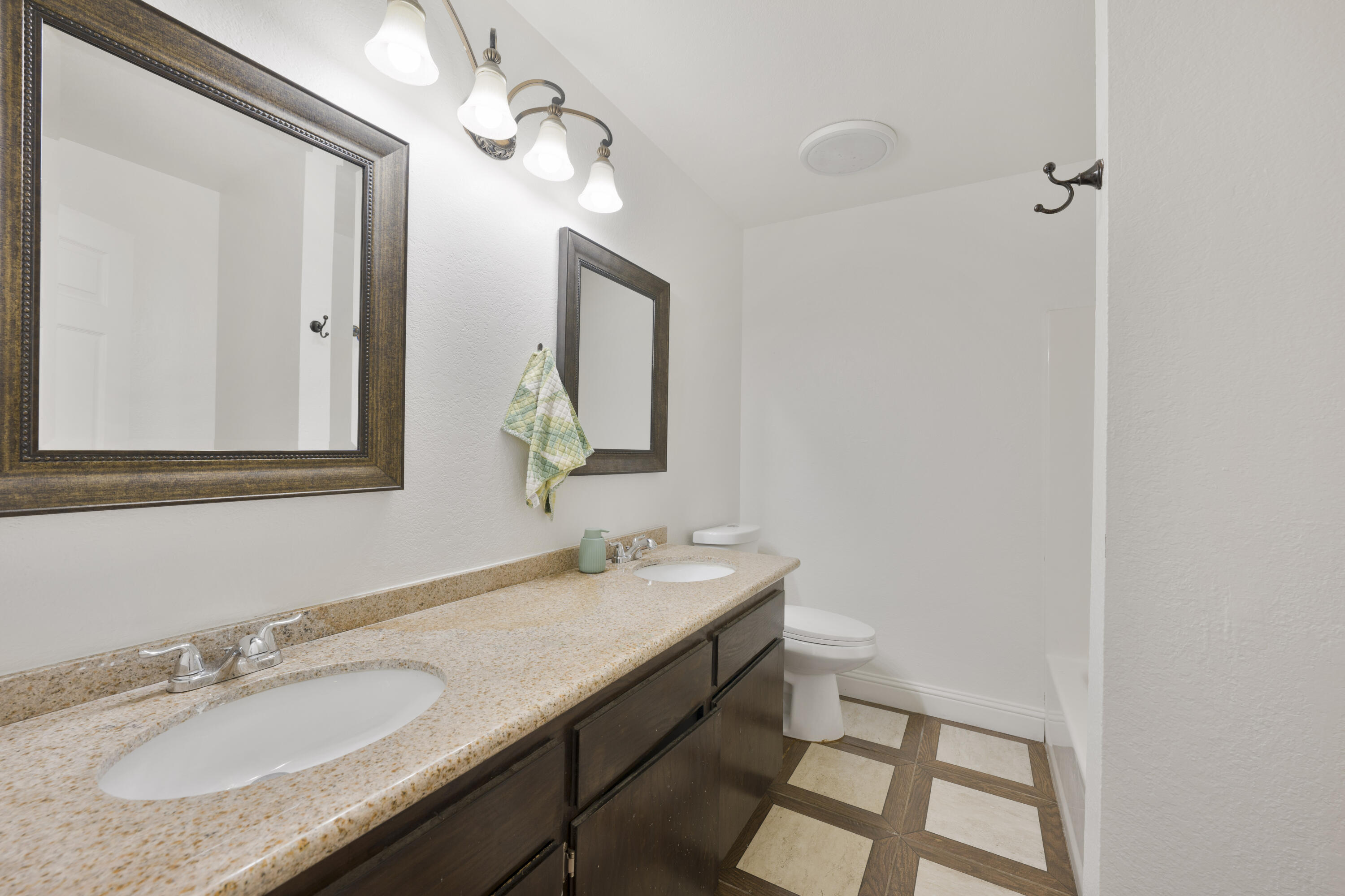 908 Northpoint Place Lompoc, CA 93436 - Photo 17 of 21 a bathroom with a granite countertop sink a mirror and a vanity