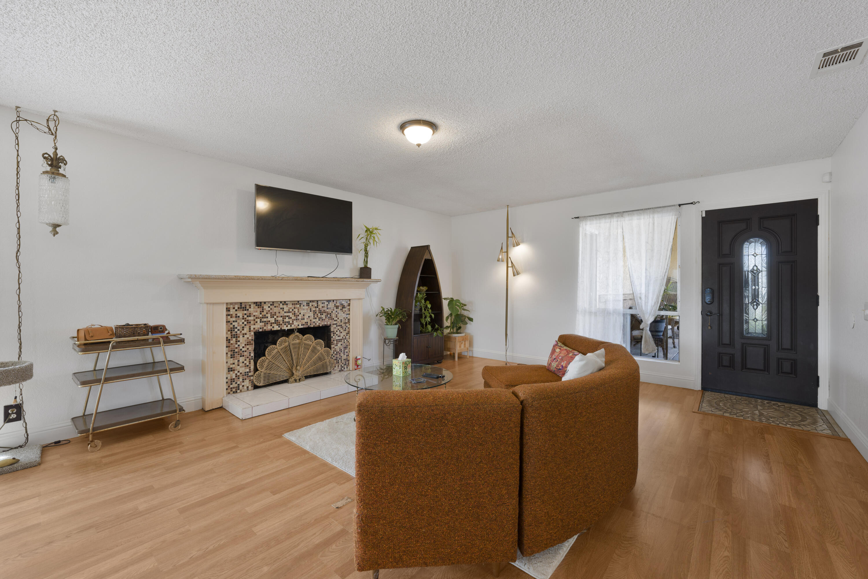 908 Northpoint Place Lompoc, CA 93436 - Photo 4 of 21 a living room with furniture a fireplace and a flat screen tv