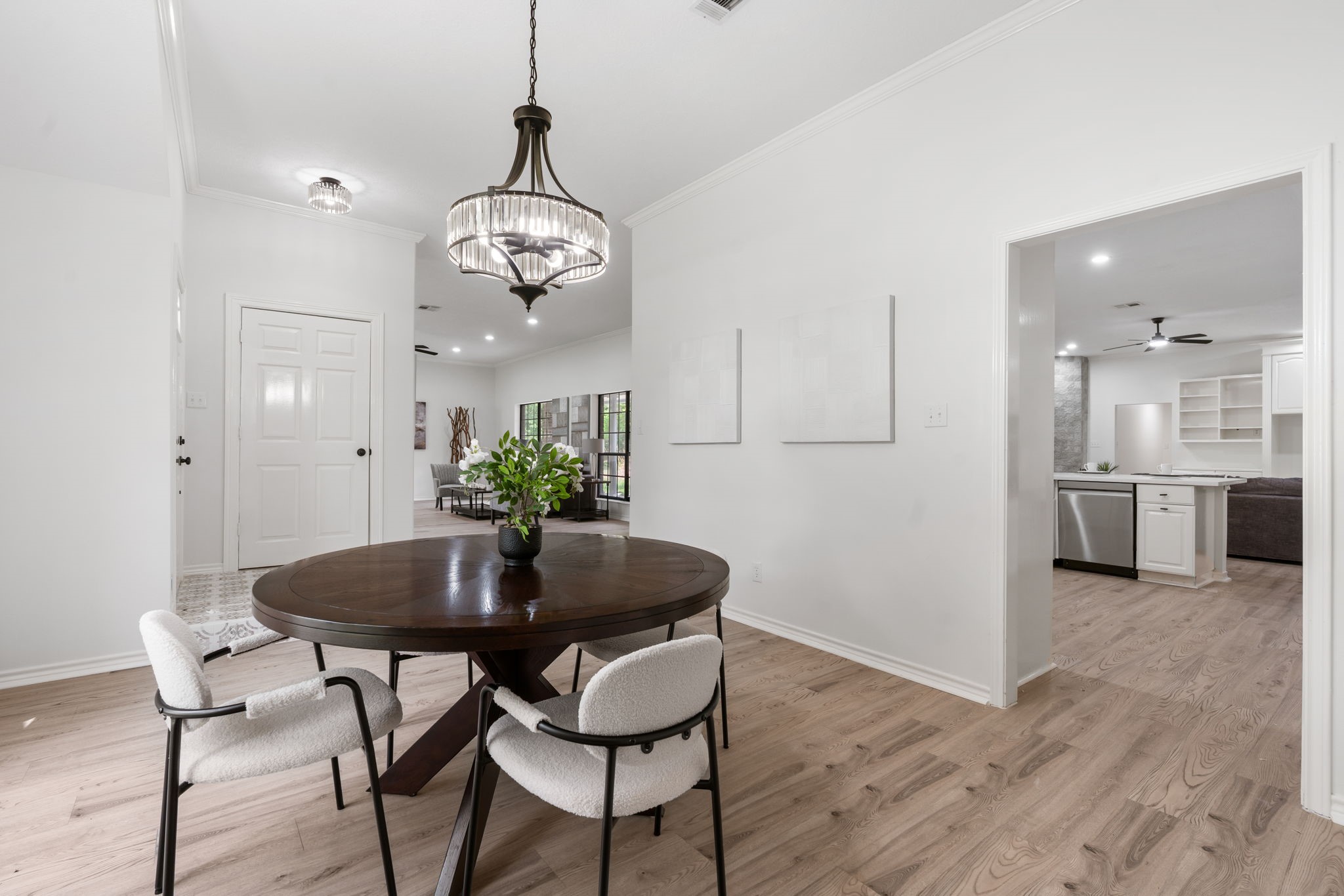 10 Autumn Oaks Drive Baytown, TX 77521 - Photo 13 of 38 a dining room with wooden floor a chandelier a glass table and chairs
