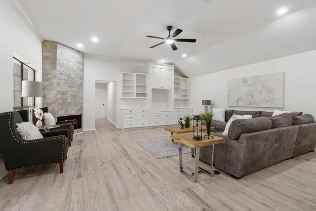 a living room with furniture and a wooden floor