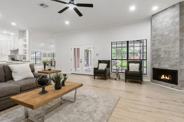 a living room with furniture and a fireplace