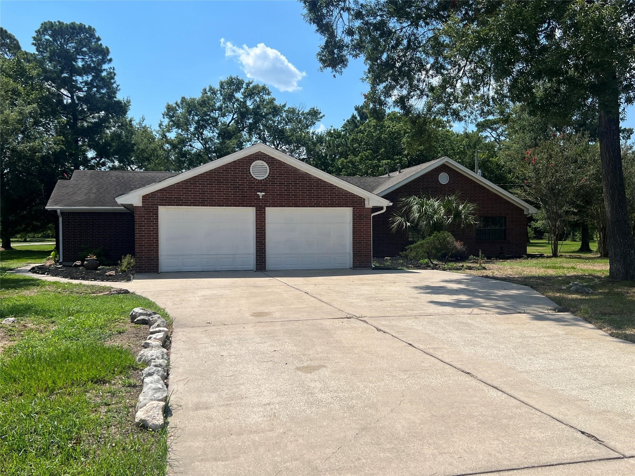 10 Autumn Oaks Drive Baytown, TX 77521 - Photo 2 of 38 a front view of a house with a yard and garage