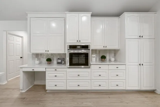a kitchen with stainless steel appliances white cabinets and a sink