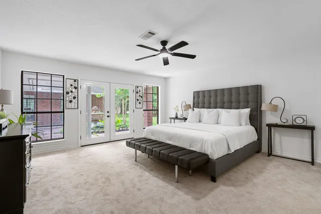 a spacious bedroom with a bed and large window