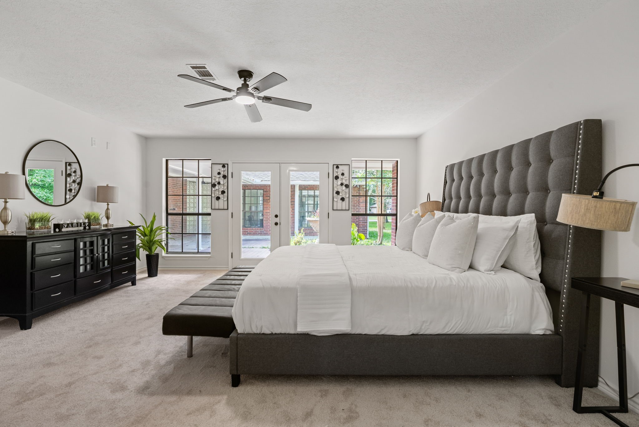 10 Autumn Oaks Drive Baytown, TX 77521 - Photo 26 of 38 a bedroom with a bed a dresser and a large window