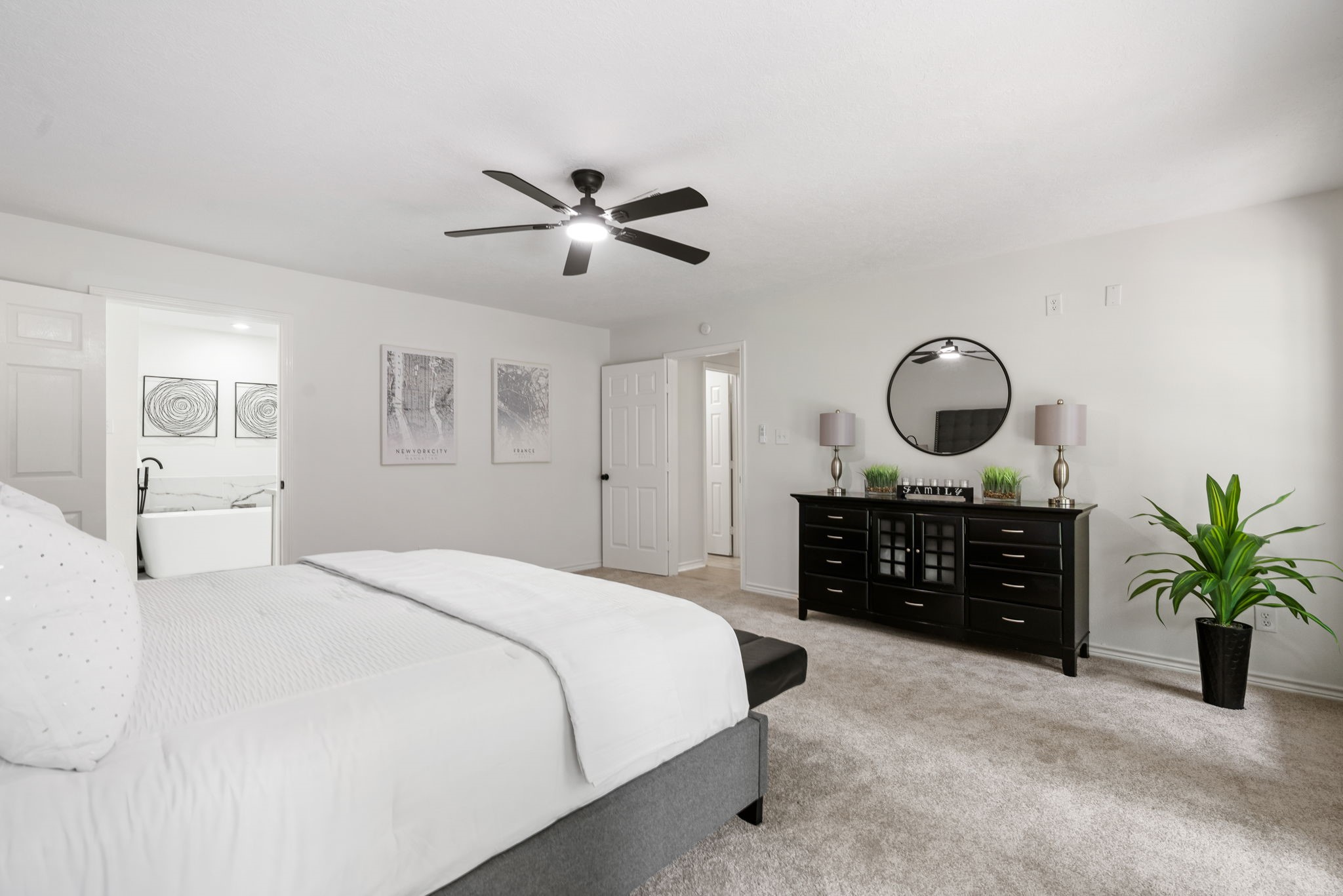 10 Autumn Oaks Drive Baytown, TX 77521 - Photo 27 of 38 a bedroom with a large bed and a chandelier