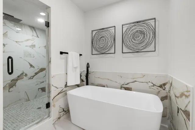 a bathroom with a bathtub and shower