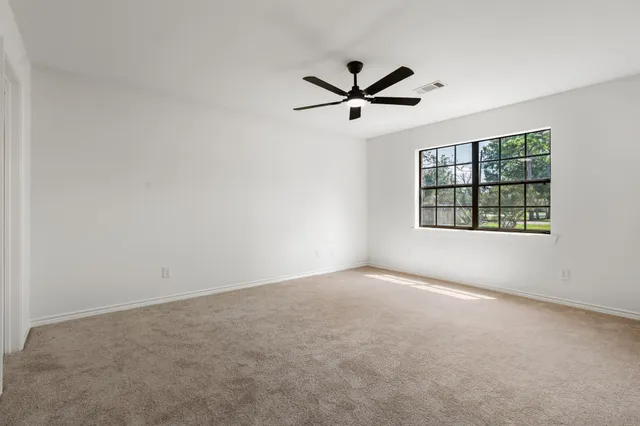 a bathroom with a granite countertop toilet sink and mirror