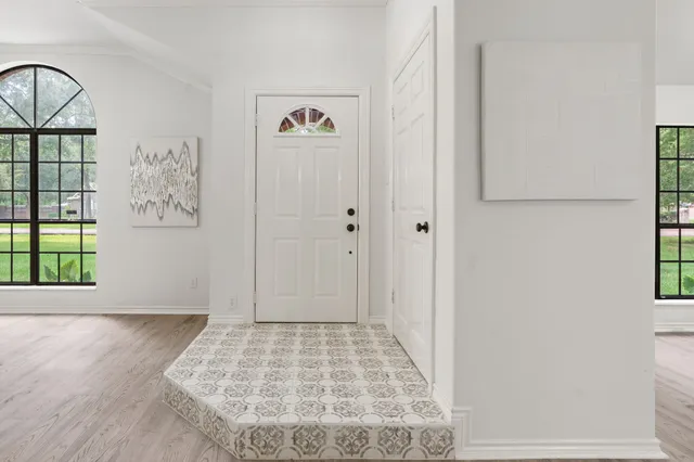 a view of an entryway with wooden floor