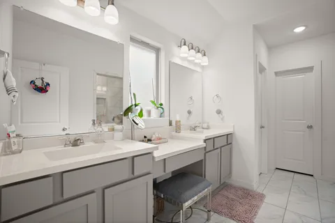 a bathroom with a double vanity sink mirror and