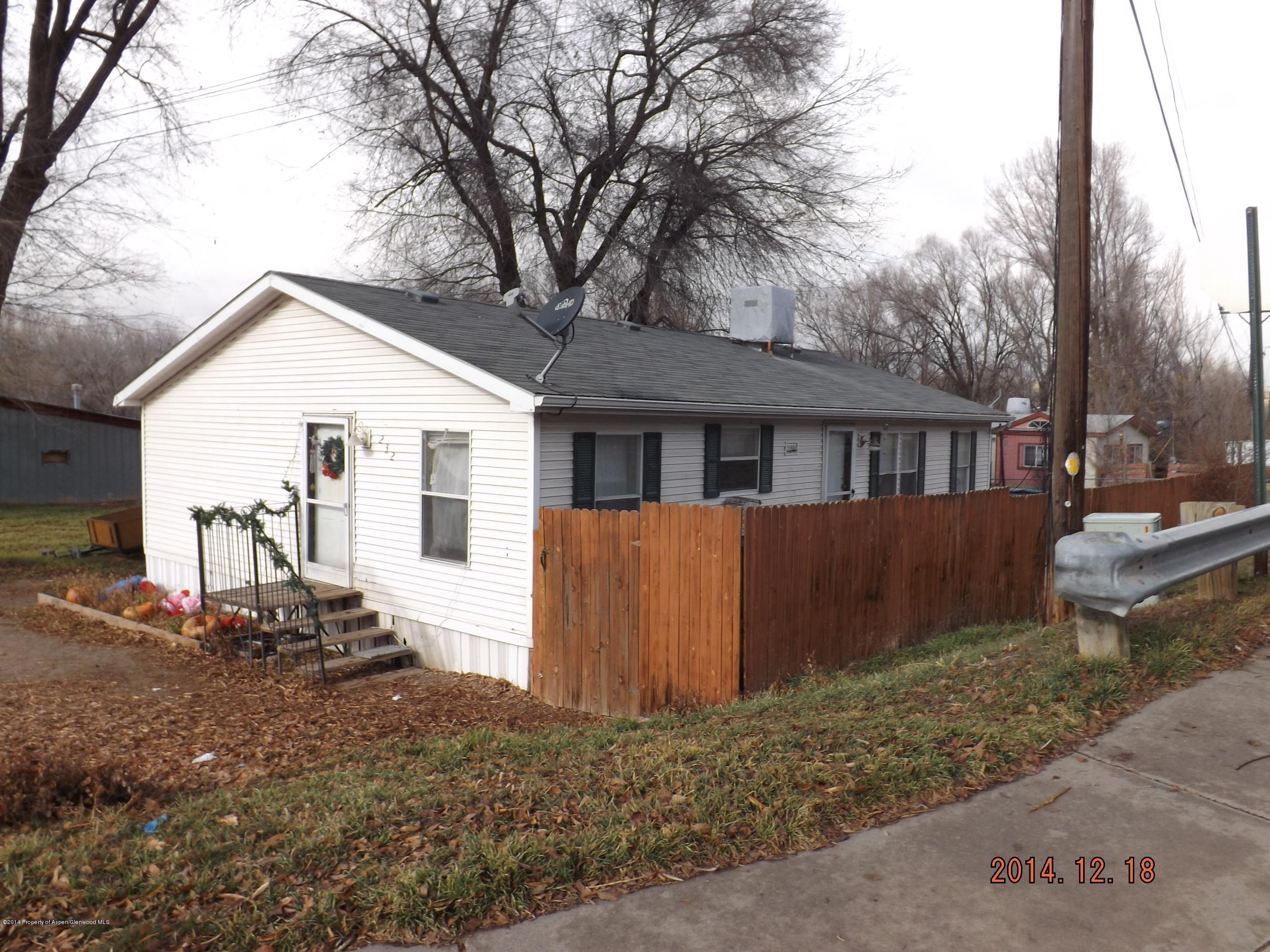 226 East 9th Street Rifle, CO 81650 - Photo 18 of 20 a front view of a house with a yard