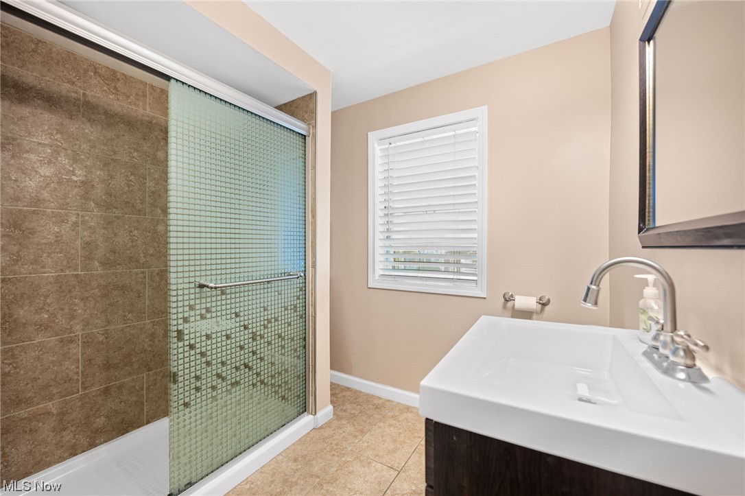 3799 Colony Road South Euclid, OH 44118 - Photo 16 of 34 Bathroom with an enclosed shower, vanity, and tile floors