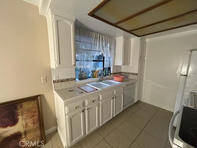 1806 North Fairview Street, Unit Q Santa Ana, CA 92706 - Photo 8 of 10 a kitchen with a sink stove and cabinets