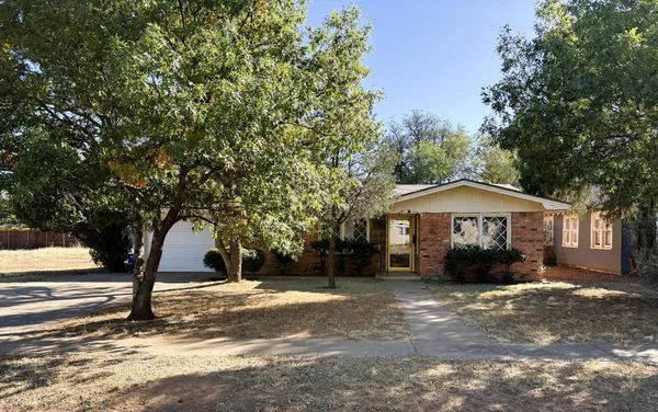 a view of a house with a tree in front