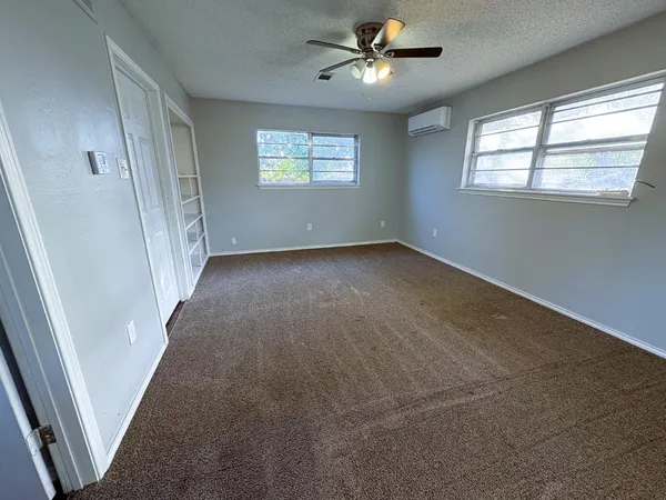 a bathroom with a sink vanity mirror and toilet