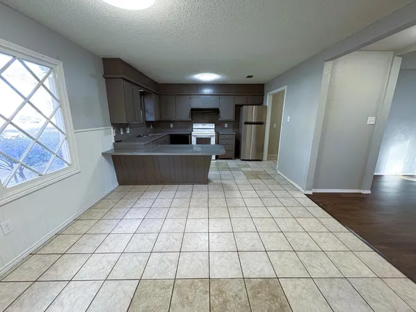 a open kitchen with stainless steel appliances a sink and cabinets