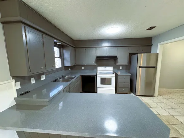 a kitchen with stainless steel appliances granite countertop a sink and cabinets