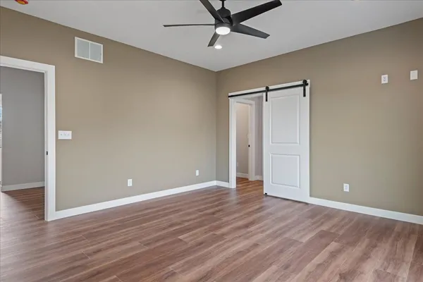 a view of an empty room with wooden floor